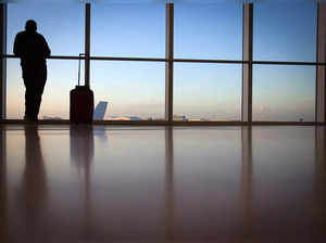 FILE PHOTO: A passenger looks out the window at Miami International Airport in Miami