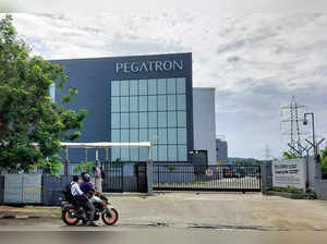 FILE PHOTO: People are seen outside the main gate of the Pegatron facility near Chennai