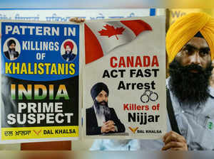 A member of a Sikh organisation holds a placard displaying Sikh separatist Hardeep Singh Nijjar in Amritsar on September 22, 2023.
