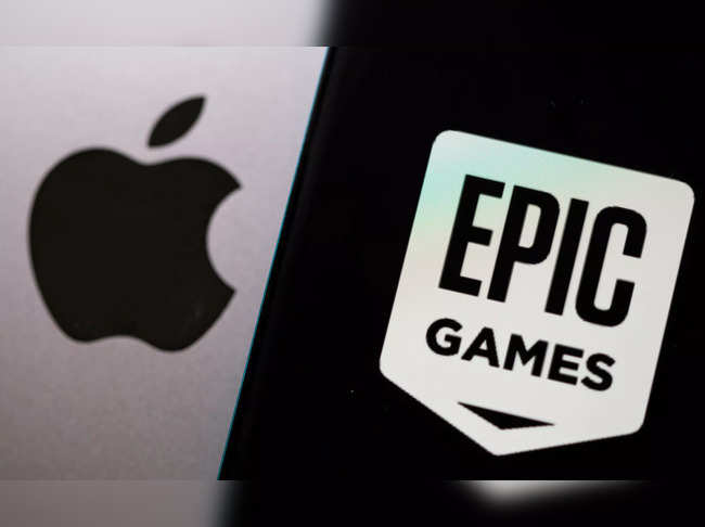Smartphone with Epic Games logo is seen in front of Apple logo in this illustration taken