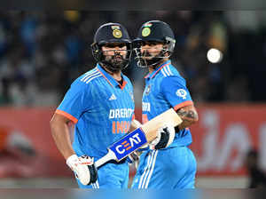 India's captain Rohit Sharma (L) and his teammate Virat Kohli run between the wickets during the third and final one-day international (ODI) cricket match between India and Australia at the Saurashtra Cricket Association Stadium in Rajkot on September 27, 2023.