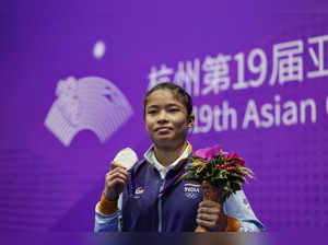 Hangzhou: India's Naorem Roshibina Devi with her silver medal poses for photogra...