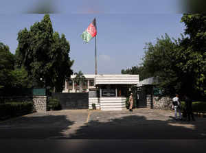 People are seen outside the Afghanistan embassy in New Delhi