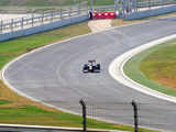 Red Bull Formula One car goes down the track during the unveiling