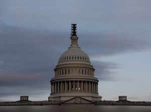 The morning sky brightens over the U.S. Capitol in Washington