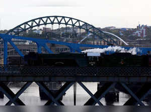 The Flying Scotsman locomotive passes over the The King Edward VII Bridge in Newcastle