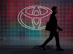 FILE PHOTO: A man walks past a Toyota logo at the Tokyo Motor Show