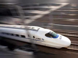 A bullet train speeds during its debut near a railway station in Shanghai.