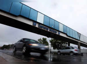 FILE PHOTO: Cars pass under an overpass at the General Motors Car assembly plant in Oshawa
