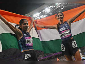 Silver medallist India’s Parul Chaudhary (R) and bronze medallist India’s Priti celebrate after the women's 3,000m steeplechase final athletics event during the 2022 Asian Games in Hangzhou in China's eastern Zhejiang province on October 2, 2023.