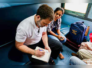 Bilaspur: Congress leader Rahul Gandhi travels in a train, in Bilaspur. (PTI Pho...