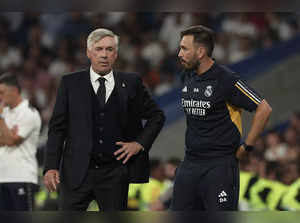 Real Madrid's Italian coach Carlo Ancelotti (L) speaks with Real Madrid's Italian assistant coach Davide Ancelotti during the Spanish league football match between Real Madrid CF and UD Las Palmas at the Santiago Bernabeu stadium in Madrid on September 27, 2023.