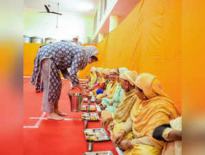 Varanasi: AICC General Secretary Priyanka Gandhi Vadra serves food to the people...