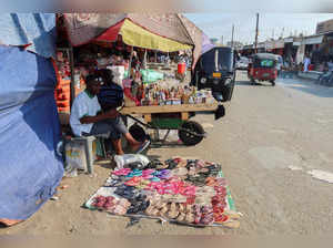 A street vendor sells shoes and slippers in Port Sudan
