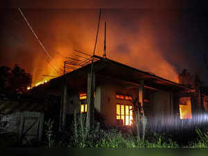 Smoke billows from an abandoned house set on fire in the violence-hit state of Manipur, in Imphal on August 5, 2023.