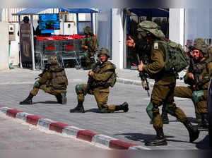 Israeli soldiers work to secure residential areas following a mass-infiltration by Hamas gunmen from the Gaza Strip, in Sderot