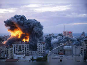 Fire and smoke rises following an Israeli airstrike, in Gaza City. The militant ...
