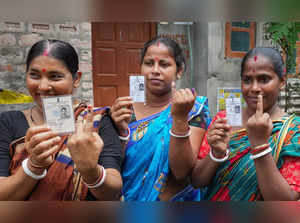 North 24 Pargana: Women voters show their inked finger after casting votes at a ...
