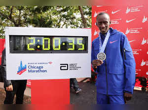 Kelvin Kiptum of Kenya poses with his medal and the clock after setting a world record marathon time of 2:00.35 during the 2023 Chicago Marathon on October 08, 2023 in Chicago, Illinois.