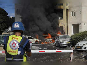 Cars are burning after a rocket fired from the Gaza Strip hit a parking lot and ...