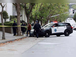 Law enforcement members stand on the street near the Chinese consulate in San Francisco, where local media has reported a vehicle may have crashed into the building