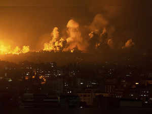 Fire and smoke rise following an Israeli airstrike, in Gaza City. The militant H...