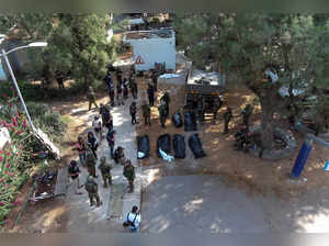 An aerial view shows the bodies of victims of an attack following a mass infiltration by Hamas gunmen from the Gaza Strip, lie on the ground in Kibbutz Kfar Aza