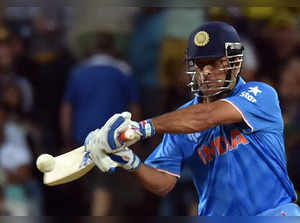 India's batsman Mahendra Singh Dhoni plays a shot against Australia during the Cricket World Cup semi-final at Sydney Cricket Ground on March 26, 2015.