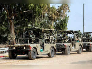FILE PHOTO: Israeli soldiers drive in military vehicles by Israel's border with Gaza in southern Israel