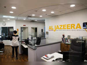 FILE PHOTO: An employee walks inside an office of Qatar-based Al-Jazeera network in Jerusalem