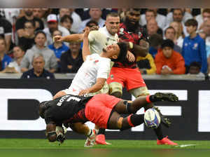 England's full-back Marcus Smith (C) is tackled by Fiji's openside flanker Levani Botia during the France 2023 Rugby World Cup quarter-final match between England and Fiji at the Velodrome stadium in Marseille, south-eastern France, on October 15, 2023.