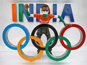 Arun Haryani poses with the Olympic rings as he cheers on India's team for the Tokyo 2020 Olympics, in Ahmedabad,