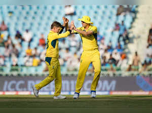 Lucknow: Australia's Adam Zampa celebrates wih captain Pat Cummins after taking ...