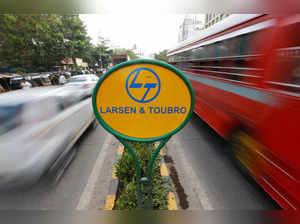 A sign of L&T is placed on a road divider in Mumbai