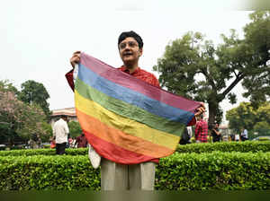 An activist holds a rainbow flag, a symbol of LGBT pride and LGBT social movements, in the courtyard of India’s Supreme Court in New Delhi on October 17, 2023, ahead of India's top court ruling on same-sex marriages.