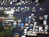 Vehicles partially submerged in a flooded area