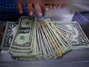 FILE PHOTO: The employee of a currency exchange shop counts U.S. dollar banknotes in Ciudad Juarez