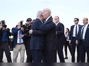 Israel Prime Minister Benjamin Netanyahu (L) hugs US President Joe Biden upon his arrival at Tel Aviv's Ben Gurion airport on October 18, 2023, amid the ongoing battles between Israel and the Palestinian group Hamas.