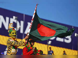 A fan waves Bangladesh's national flag before the start of the 2023 ICC Men's Cricket World Cup one-day international (ODI) match between England and Bangladesh at the Himachal Pradesh Cricket Association Stadium in Dharamsala on October 10, 2023.
