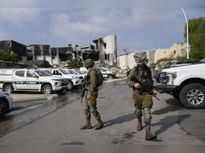 Israeli soldiers walk near the police station that was overrun by Hamas militant...