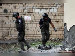Israeli police inspect the damage caused by a rocket after if was fired from the Gaza Strip towards Israel, in Ashkelon