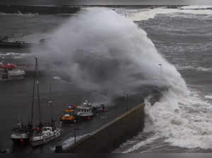 Waves crash over the harbour wall as storm Babet approaches Stonehaven, Scotland