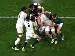 England's openside flanker Tom Curry (CR) tackles a South Africa player during the France 2023 Rugby World Cup semi-final match between England and South Africa at the Stade de France in Saint-Denis, on the outskirts of Paris, on October 21, 2023.