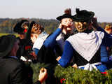 Farmers' wives dressed in traditional Bavarian costumes drink Schnaps