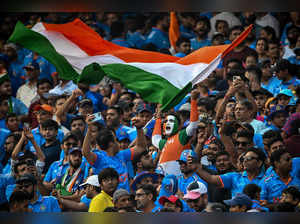 Fans cheer for team India during the 2023 ICC Men's Cricket World Cup one-day international (ODI) match between India and Pakistan at the Narendra Modi Stadium in Ahmedabad on October 14, 2023.