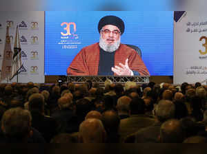 Lebanon's Hezbollah leader Sayyed Hassan Nasrallah gestures as he addresses his supporters through a screen in Beirut's southern suburbs, in Beirut