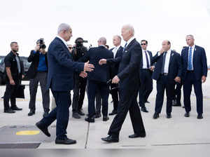 Israel Prime Minister Benjamin Netanyahu (L) greets US President Joe Biden upon his arrival at Tel Aviv's Ben Gurion airport on October 18, 2023, amid the ongoing battles between Israel and the Palestinian group Hamas.