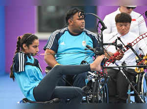 India's Devi Sheetal (L) and Kumar Rakesh compete in the mixed team compound - open gold medal archery match during the 2022 Asian Para Games in Hangzhou, in China's eastern Zhejiang province on October 26, 2023.