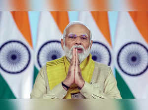 New Delhi, July 21 (ANI): Prime Minister Narendra Modi greets while addressing t...