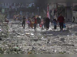 Palestinians leave their homes following Israeli bombardment on Gaza City.AP/PTI...
